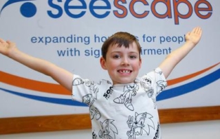 Photo of Harris in front of the seescape logo